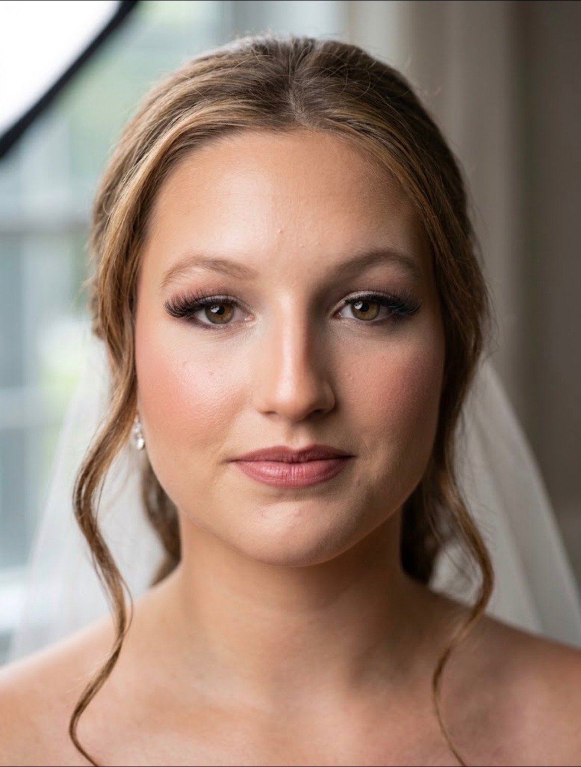 Bride or wedding party member wearing professional bridal makeup by Evolved Beauty
